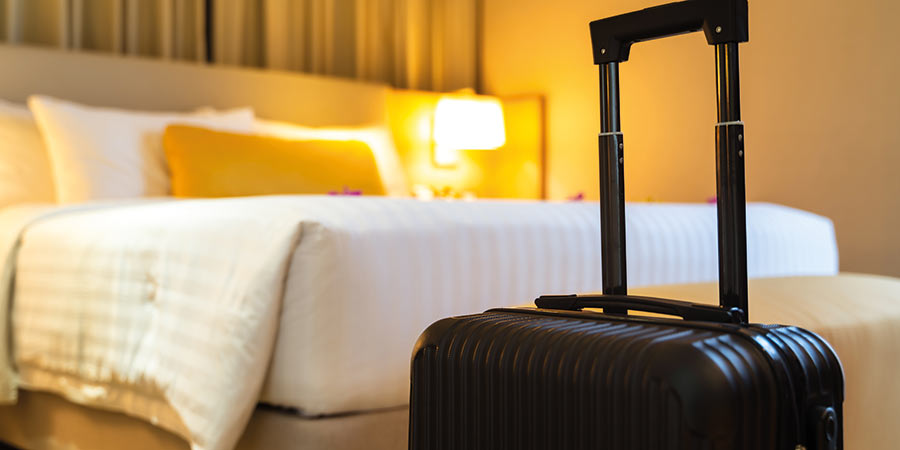 A suitcase sits in a hotel room.